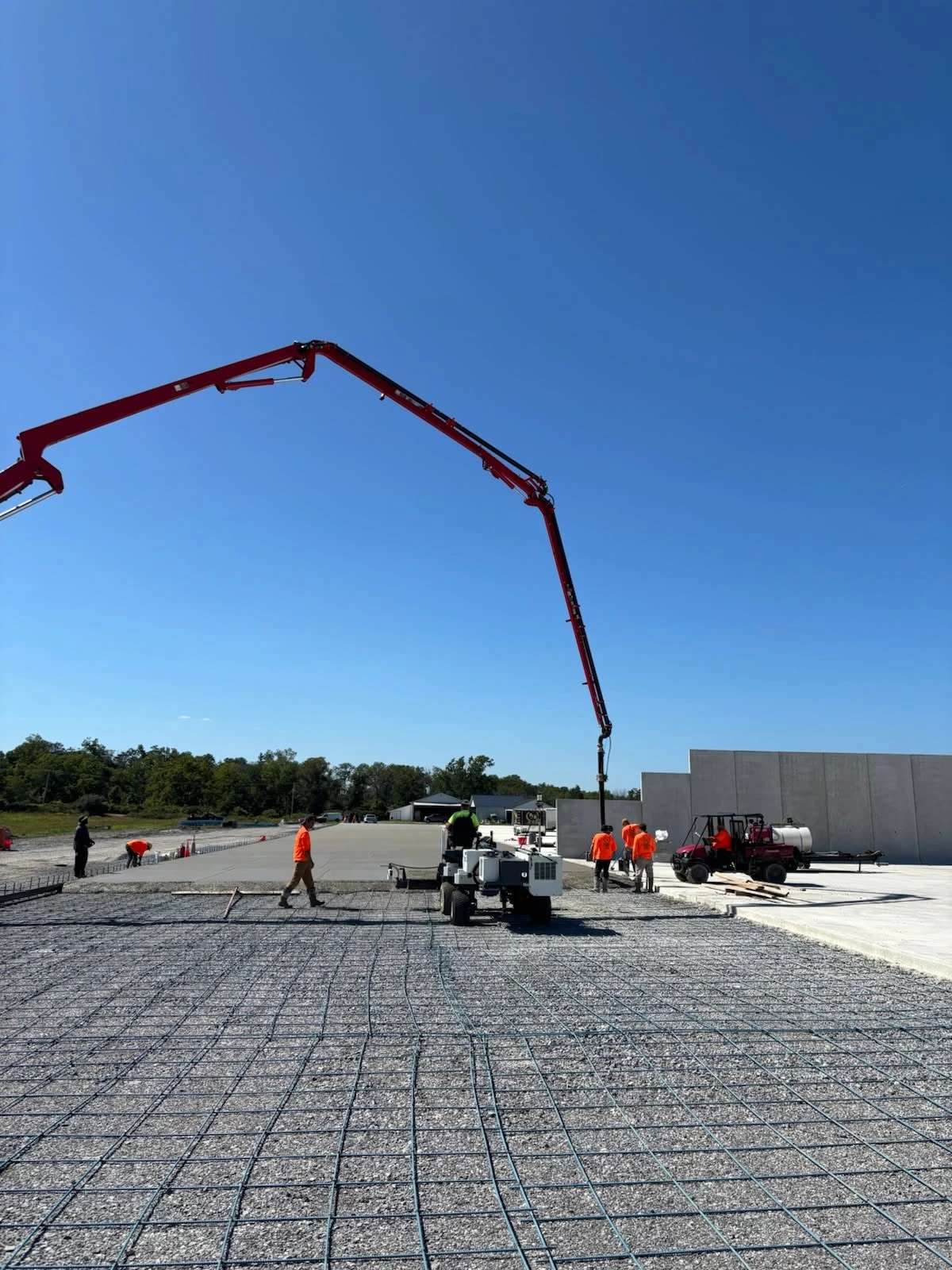 R&R concrete placement crew with pump and screed equipment